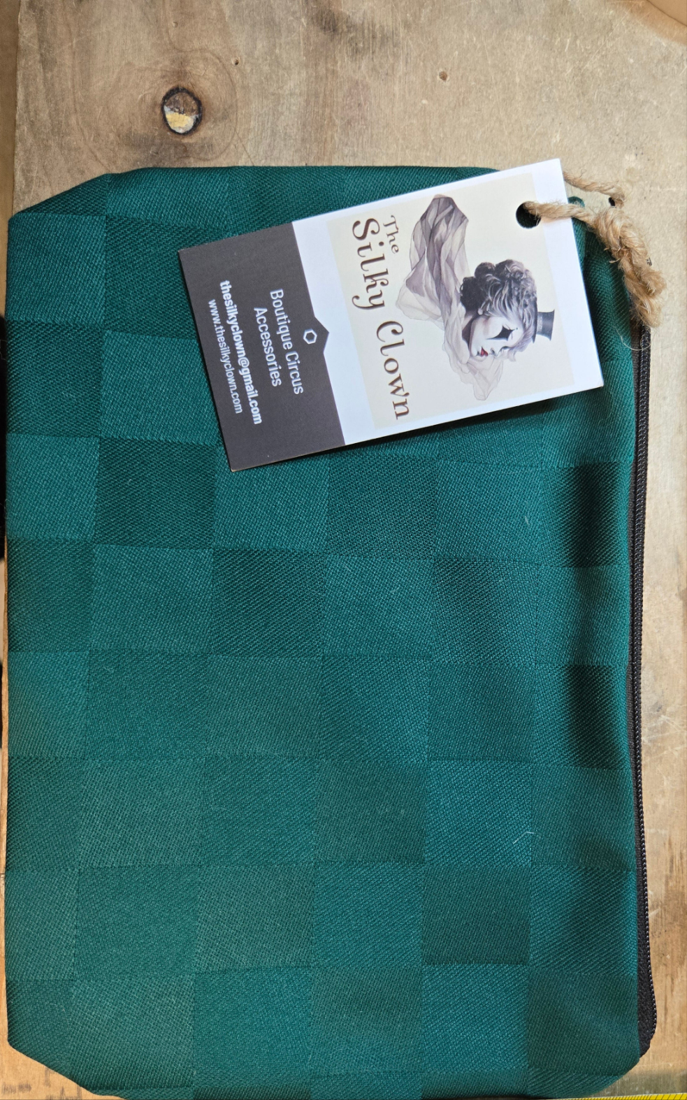Teal checkered cloth gear bag with drawstring and fabric loop pull