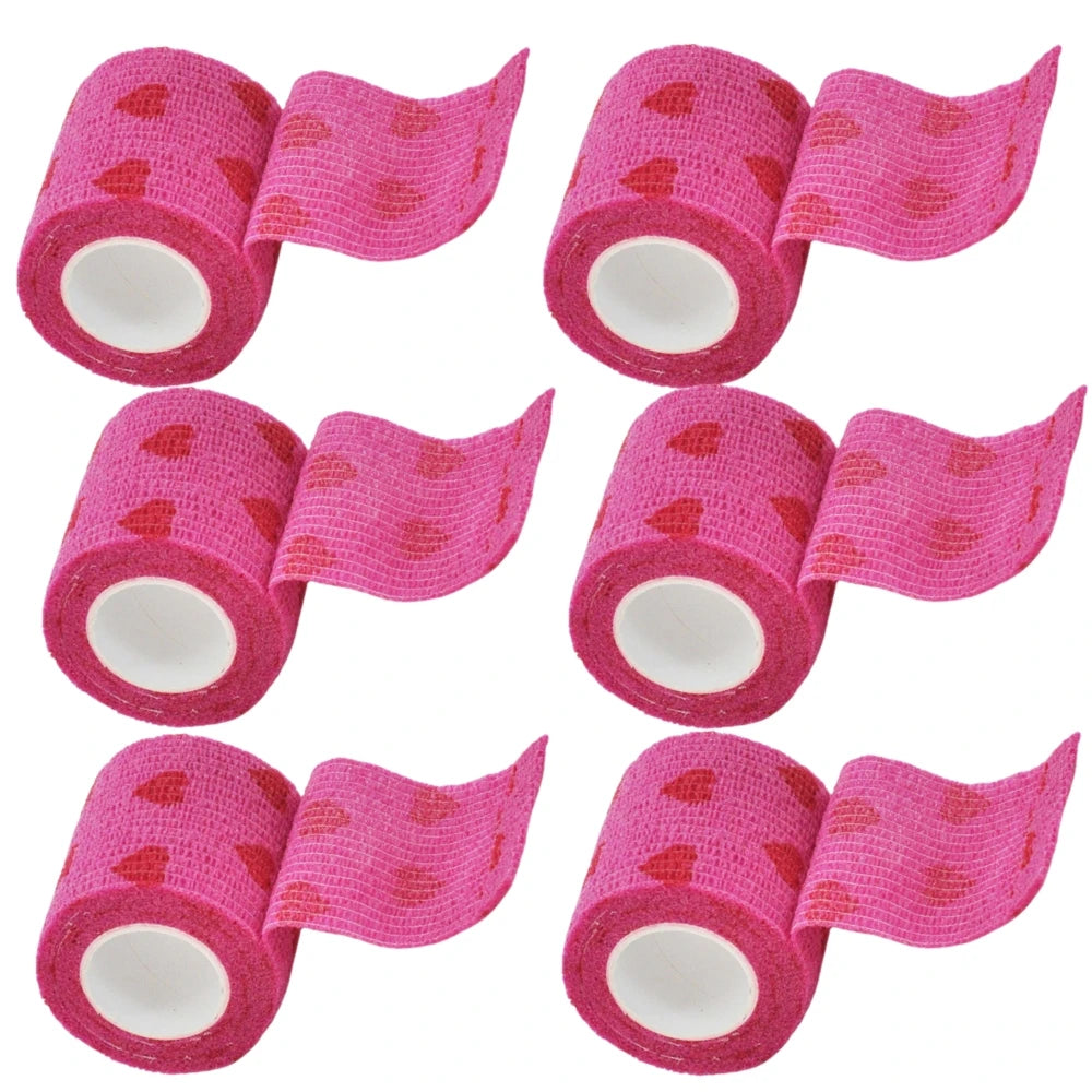 Set of pink self-adhesive bandage rolls with heart pattern and roll ends