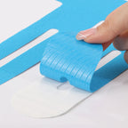 Blue kinesiology tape strip laid out flat with adhesive backing