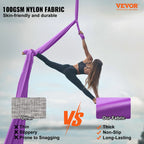 Purple aerial hammock silk sling for yoga, suspended from a ceiling strap