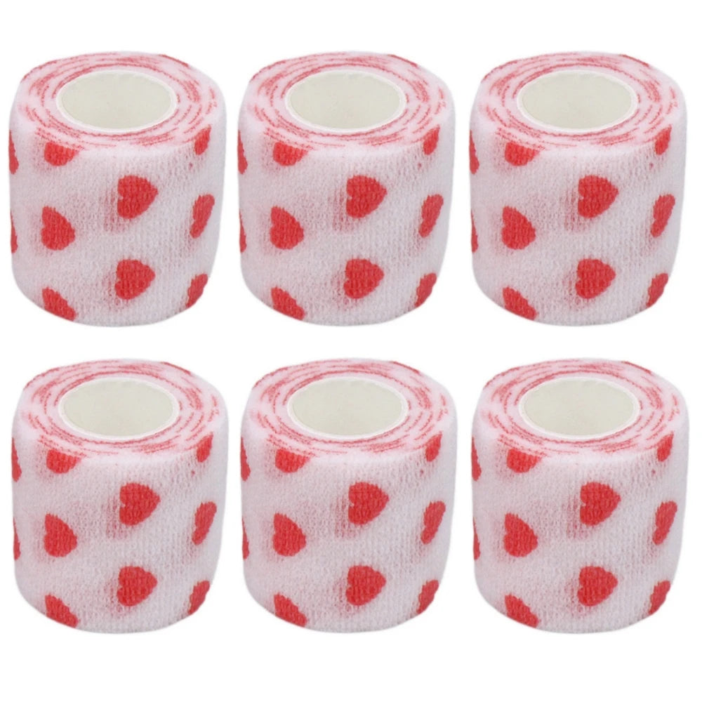 Set of pink-and-white bandage rolls with red heart pattern and white inner cores