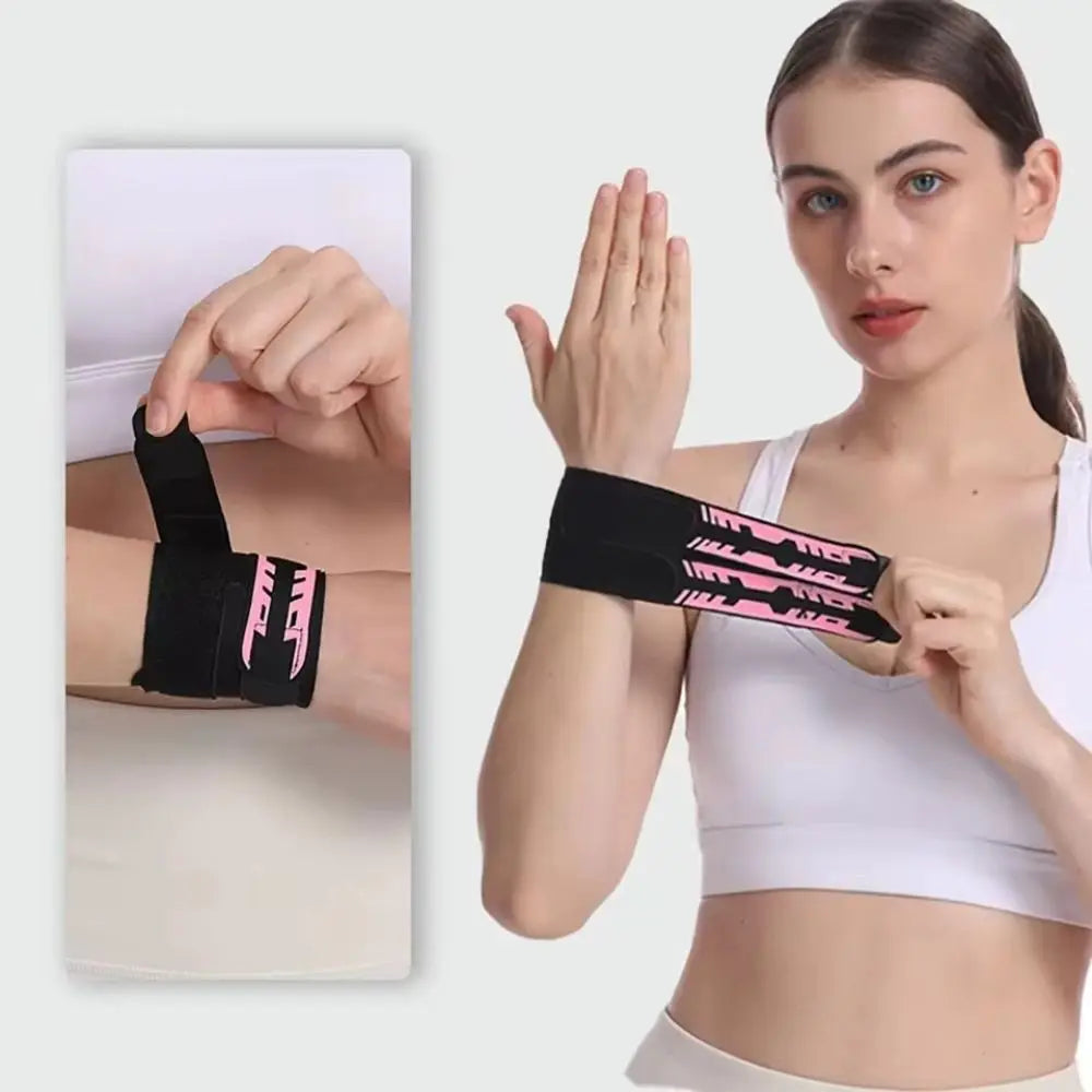 Black wrist support brace with pink logo, worn on wrist with adjustable double bands