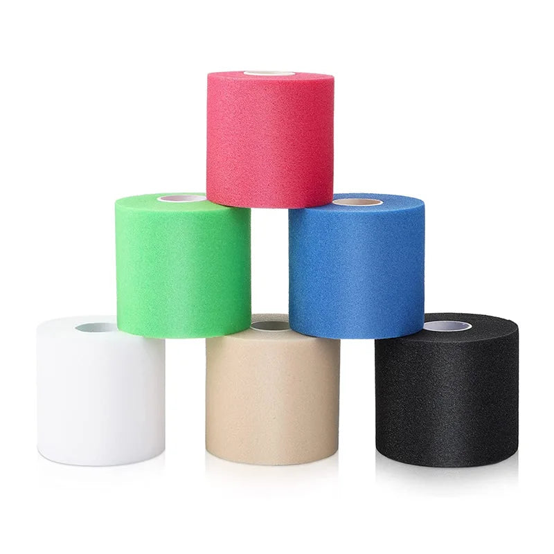 Foam underwrap tape rolls stacked in white, green, blue, pink, tan, and black
